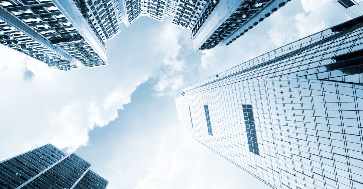 Skyline of city financial buildings in glass against a cloudy sky