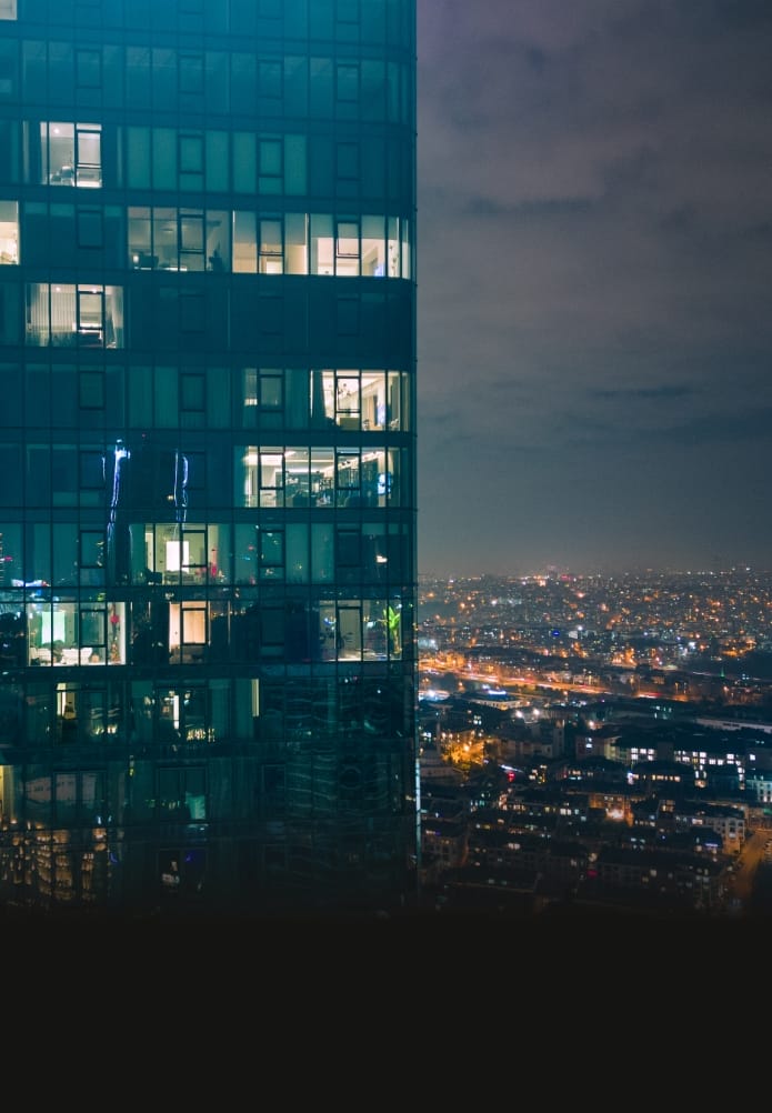 Istanbul's glass and concrete skyscrapers, home to offices, hotels, and residential complexes at night. Aerial drone view
