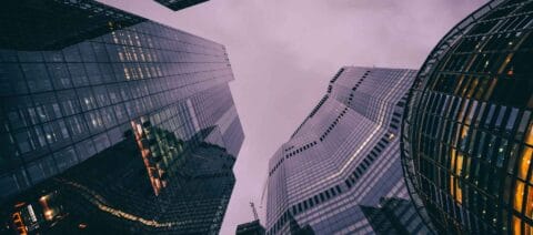 Financial skyscraper photographed from a low angle at dusk.